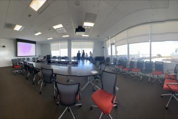 Board room from the entrance showing seating around the table and panoramic windows.