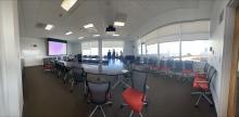 Board room from the entrance showing seating around the table and panoramic windows.