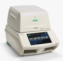 An off-white, cube shaped device, the Bio-rad CFX96 qPCR machine, sits on a white background